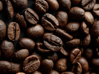 Coffee beans in a holder on a black background