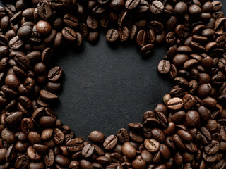 Coffee beans in a holder on a black background. Place for text