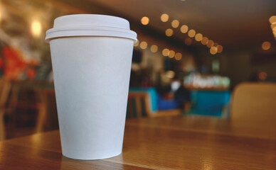 takeaway cup of coffee in coffee shop background, Selective focus. Mockup concept.