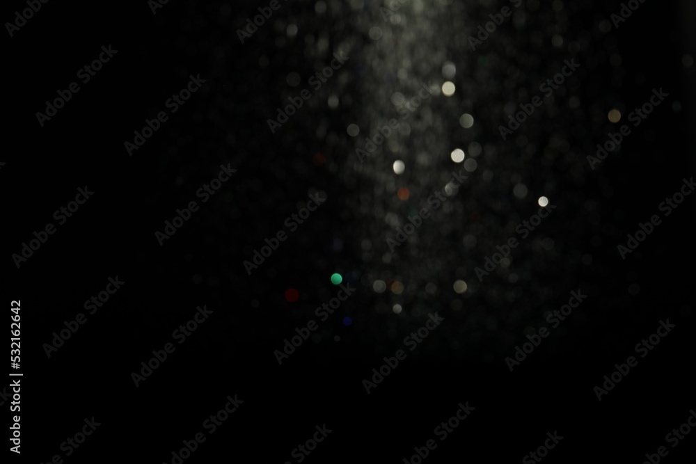 Wall mural blurred view of festive lights on black background. bokeh effect