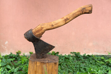 Antique sharp ax in a log