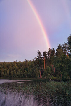 Rainbow reflected in the lake when it rains. Nature photos from Sweden