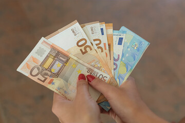Woman hold Euro currency banknotes bills,save money,economy business finance crisis