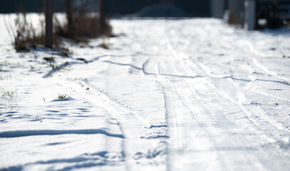 Dirt road covered with snow. Packed snow on the access road to the property. Winter in the...