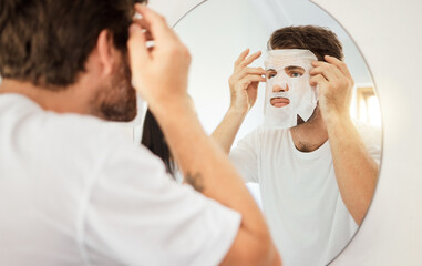 Skincare, face and facial mask on man on mirror in home bathroom. Young male with self care, beauty or cosmetic cleaning for skin health and wellness for anti aging moisturizer product for detox