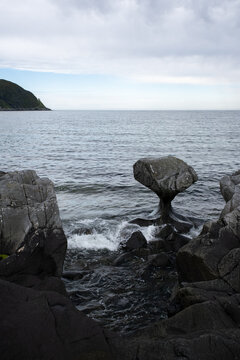 Wonderful landscapes in Norway. Vestland. Beautiful scenery of Kannesteinen It's a special stick-shaped stone that lies on the shore in the village of Oppedal, west side of Vagsoy. Selective focus