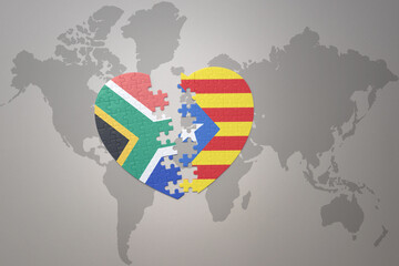 puzzle heart with the national flag of south africa and catalonia on a world map background. 3D illustration