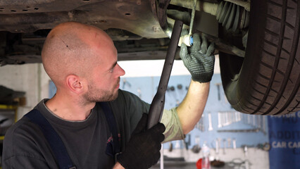 Car diagnostics. an auto mechanic inspects a car. auto repair shop. breaking. transmission