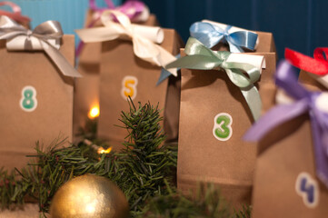 advent calendar with craft packages and signed dates, multi-colored ribbons with a task