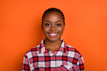 Photo of charming funny woman wear checkered shirt smiling isolated bright vivid orange color background