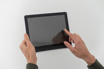 hands of a man holding blank tablet device.