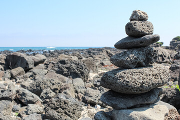 Fototapeta na wymiar Stone tower on the beach. basalt