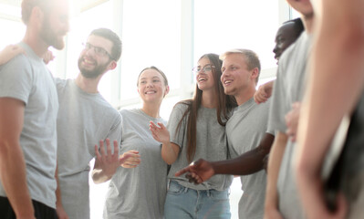 group of diverse young men in grey t-shirts standing together