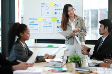 Female Operations Manager Holds Meeting Presentation for a Team of Economists. Asian Woman Uses Digital Whiteboard with Growth Analysis, Charts, Statistics and Data. People Work in Business Office.