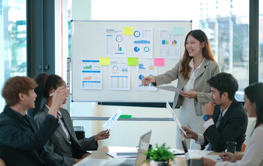 Female Operations Manager Holds Meeting Presentation for a Team of Economists. Asian Woman Uses Digital Whiteboard with Growth Analysis, Charts, Statistics and Data. People Work in Business Office.