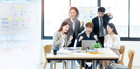 Group of Young Asian business team creative business people coworker in office Happy to be successful partnership teamwork celebrating achievement and Asian success concept.
