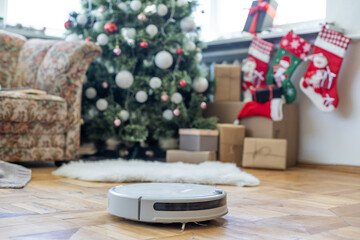 Robotic vacuum cleaner hoovering the floor at christmas