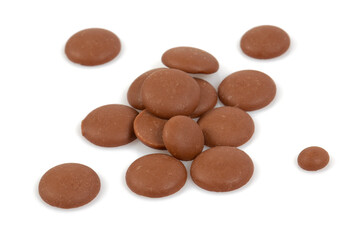 Tasty chocolate morsels isolated on white background.