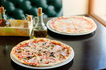 Beautiful pizza with a ham on a table