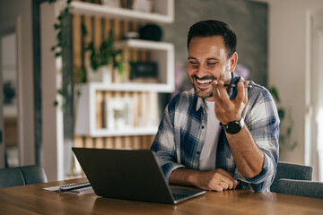 An adult man talking to someone over the phone, working over the