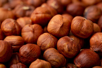 Heap of hazelnuts close-up. Peeled nuts. Hazelnut isolated on white background.