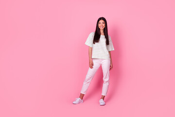 Full size photo of cheerful satisfied filipino person standing posing isolated on pink color background