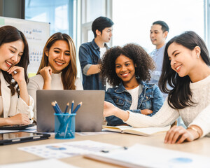 Young and successful mixed race, asian business people working on project together, sitting at table in boardroom.
