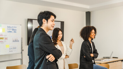 Multiracial business team on a meeting in a modern bright office, Diverse colleagues working on project together, sitting at table in boardroom.