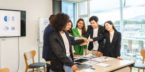 Happy working together successful team of business people mixed race teamwork join hand at office workplace.