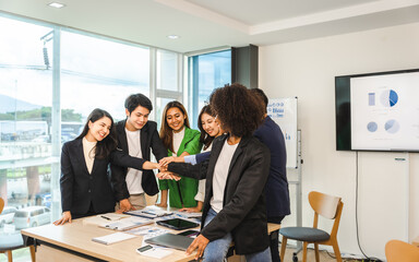 Happy working together successful team of business people mixed race teamwork join hand at office workplace.