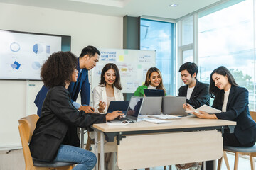 Obraz premium Mix race young start up business people meeting at office desk in modern workplace.