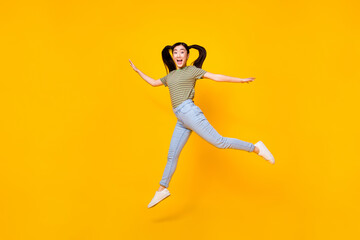 Fototapeta na wymiar Full body photo of young cheerful girl playing active energetic game with friends isolated on yellow color background