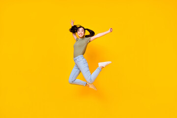 Fototapeta na wymiar Photo of good mood energetic active girl jumping up in excitement win lottery money isolated on yellow color background