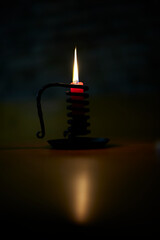 burning candle on black background