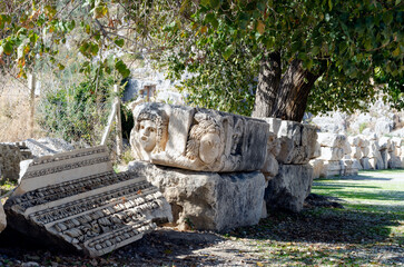 Historical stone theatrical masks bas relief of amphitheater at ancient city Myra. Territory of modern Demre city, Antalya province, Turkey