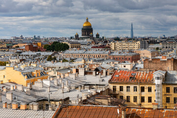 Fototapeta na wymiar Russia. Saint-Petersburg. Roofs of St. Petersburg. View of the historical center of the city and St. Isaac's Cathedral from the top point.