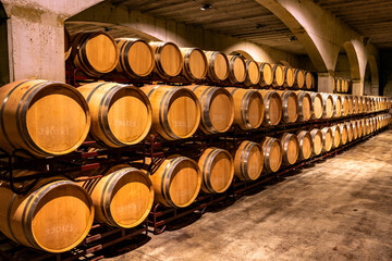 Stacked wine barrels. Wooden barrels containing macerating wine.