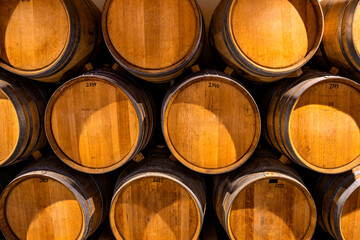 Stacked wine barrels. Wooden barrels containing macerating wine.