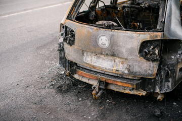 Fototapeta premium Wreck of burned car on the side of the road