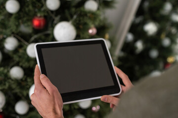 hands of a man holding blank tablet device.