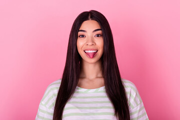 Portrait of positive pretty person beaming smile showing tongue out isolated on pink color background