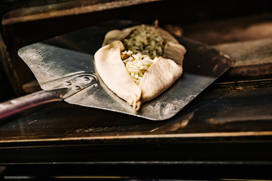 Chef Baker Making Pide At Kitchen. Put On Landing Shovel And Send It To The Oven.