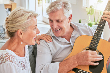 Senior couple with guitar for music and singing together on sofa for retirement lifestyle and...