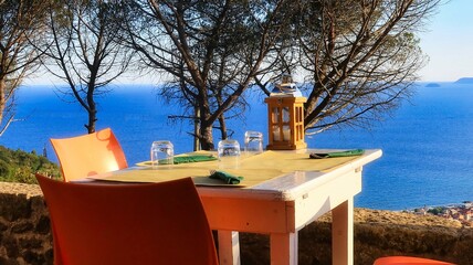 tables of a restaurant with a beautiful sea view in a western Ligurian restaurant in borgio verezzi, during the summer of 2022