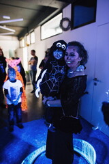 Show of soap bubbles, fluorescent paint illuminated by ultraviolet light. People at a Halloween...