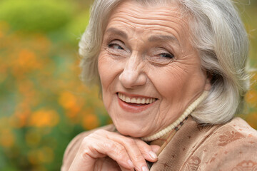 Senior woman walking in the park in autumn