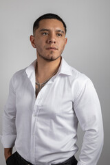 young latin man with short hair wear a white shirt, formal fashion in studio, beauty and lifestyle