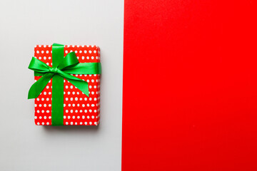 holiday paper present tied yellow ribbon bow top view with copy space. Flat lay holiday background. Birthday or christmas red present. Christmas gift box concept with copy space