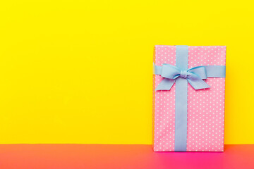 holiday handmade paper present tied blue ribbon bow top view with copy space. Flat lay holiday background. Birthday or christmas present. Christmas gift box concept with copy space