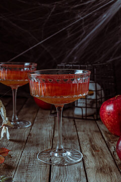 Red Apple Cocktail With Shimmer For Halloween Party On Wooden Rustic Backgroud